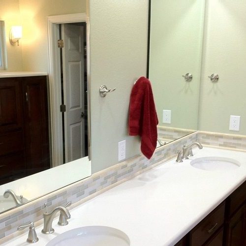 A Picture of a Bathroom Mirror with Vanity.